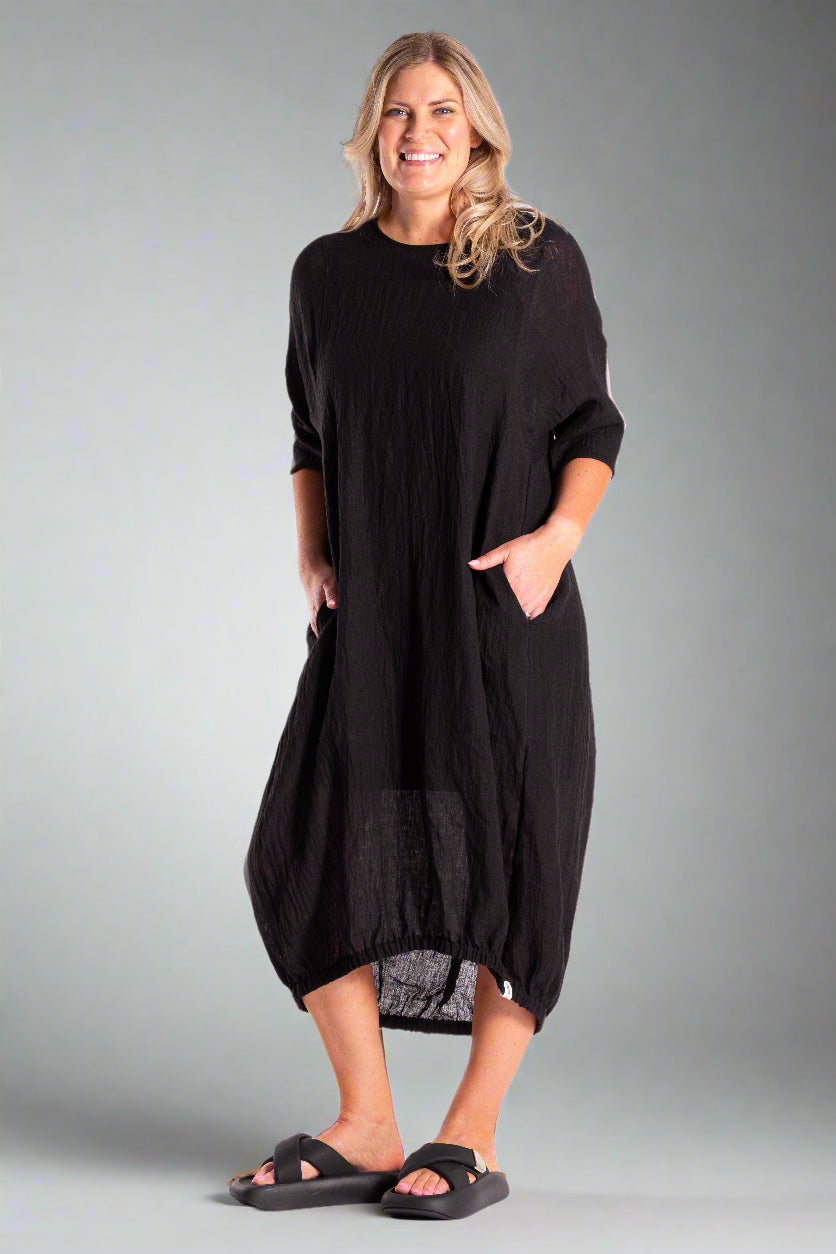 Woman wearing a black dress on a white background