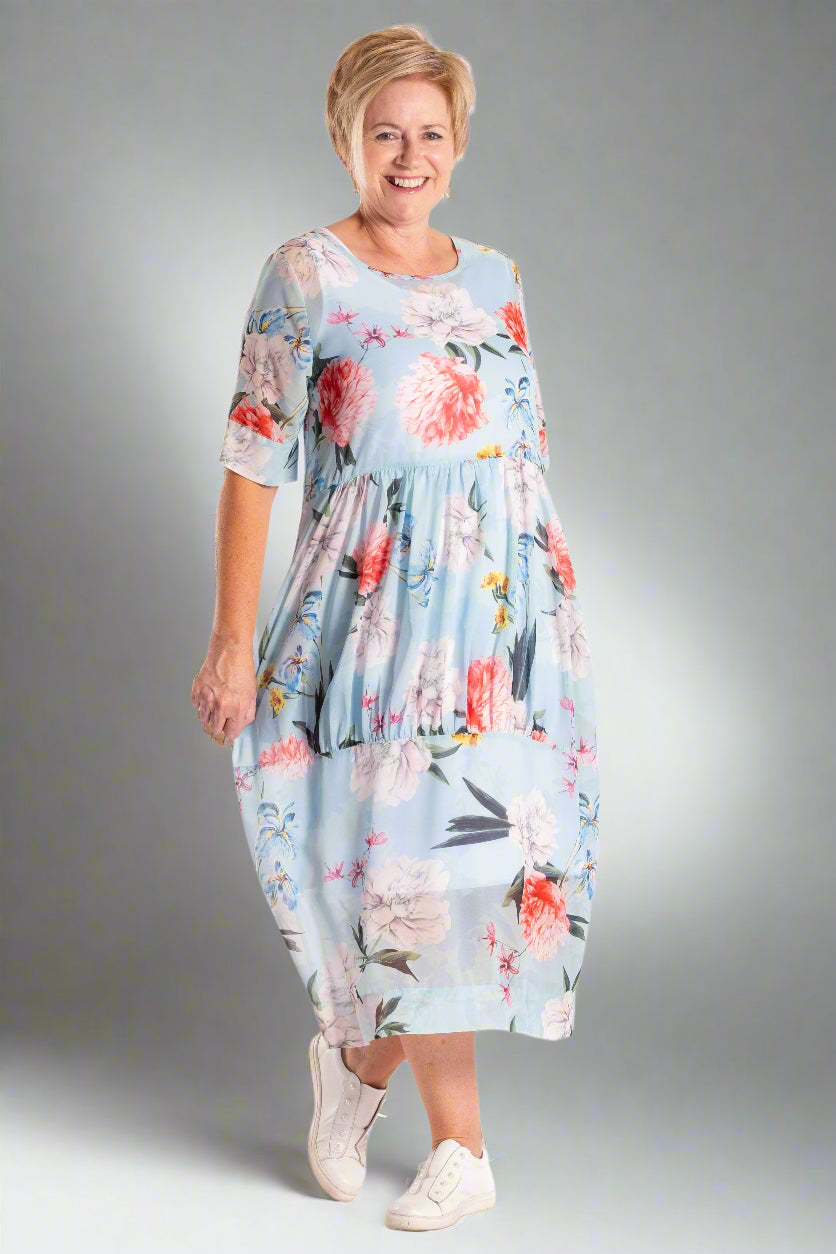 Woman wearing a floral dress on a white background