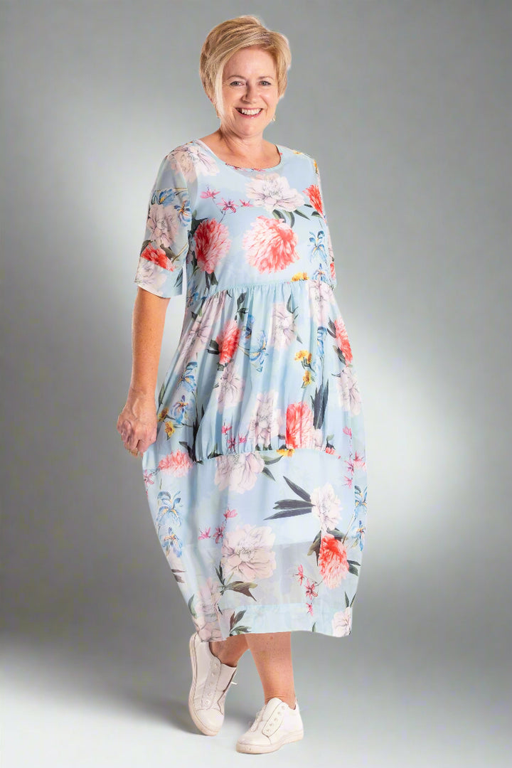 Woman wearing a floral dress on a white background