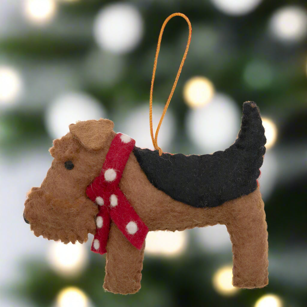 Felt dog ornament with a red scarf on a white background