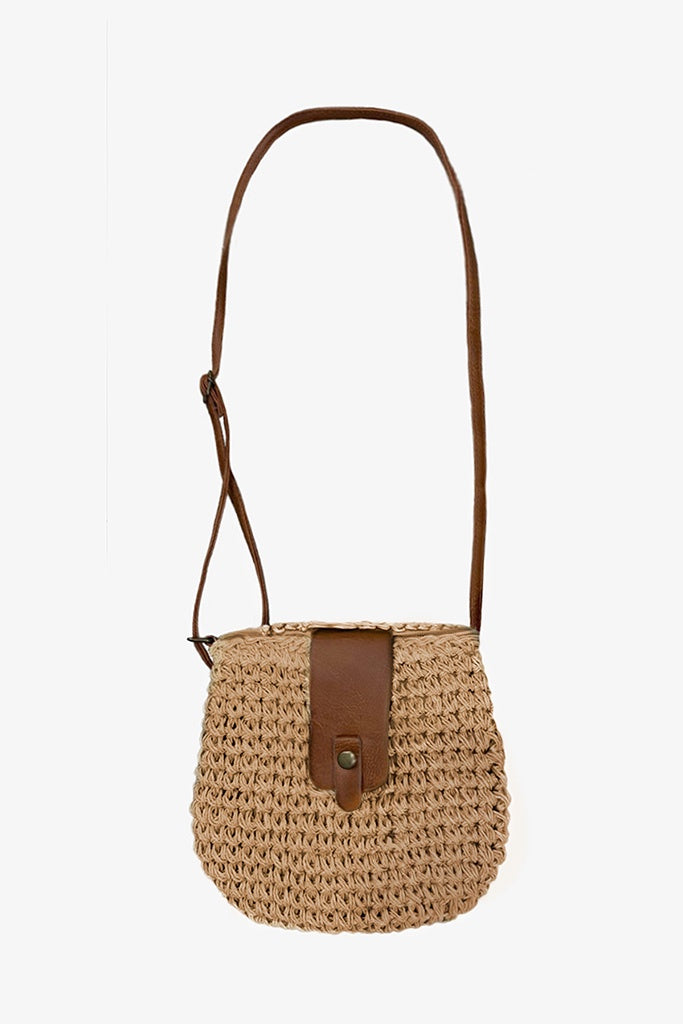 Woven handbag with leather strap on a white background