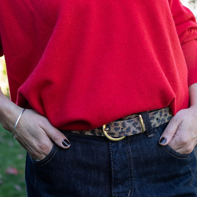 Person wearing a red sweater with a blurred outdoor background