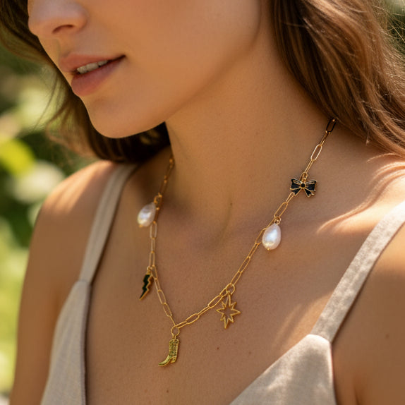 Necklace with various charms including a boot, star, and lightning bolt on a white background