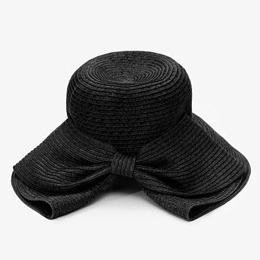 Black straw hat with a large bow on a white background