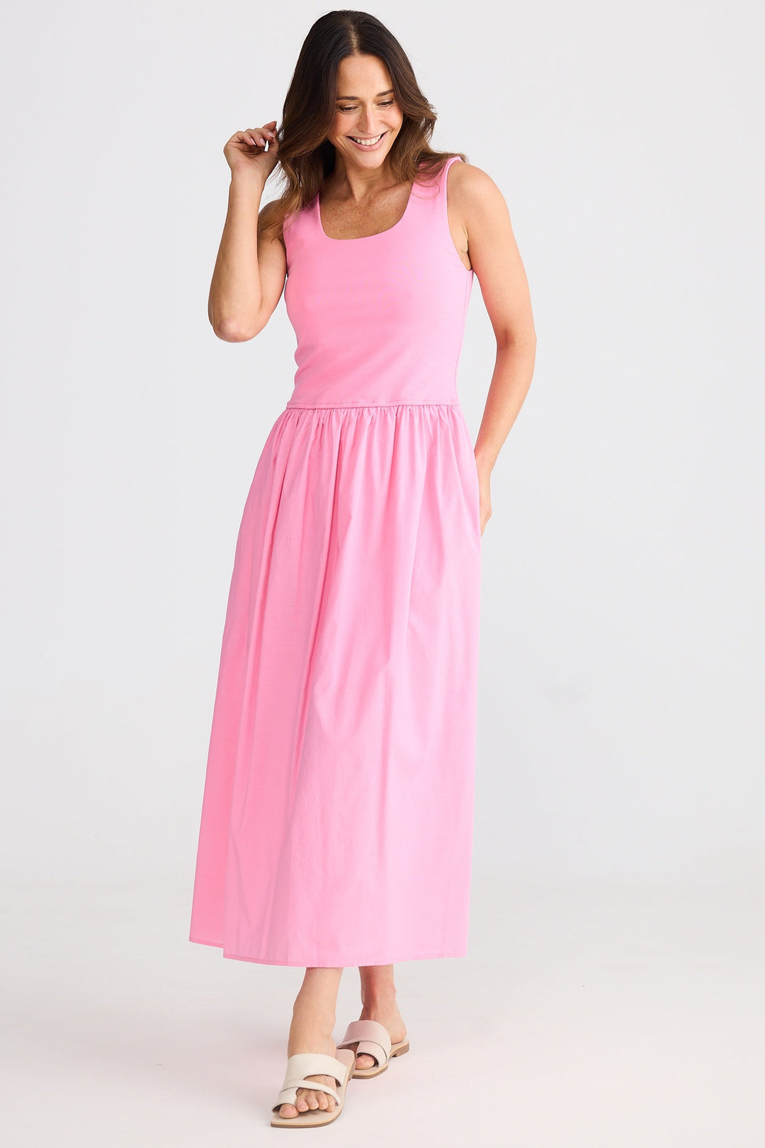 Woman wearing a pink brave & true dress on a white background