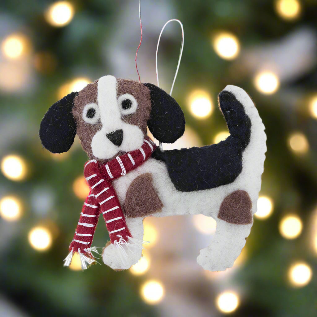 Felt dog ornament with a red and white striped scarf on a white background