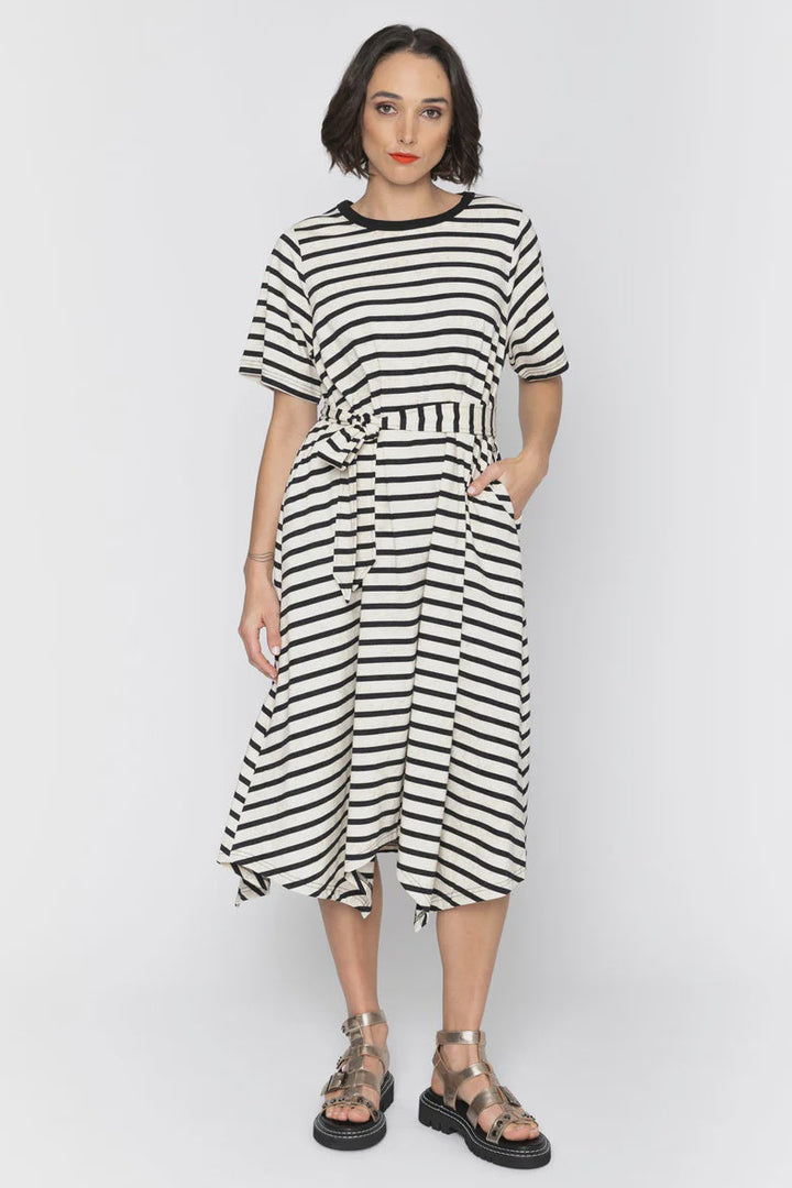 Woman wearing a black and white striped dress on a white background