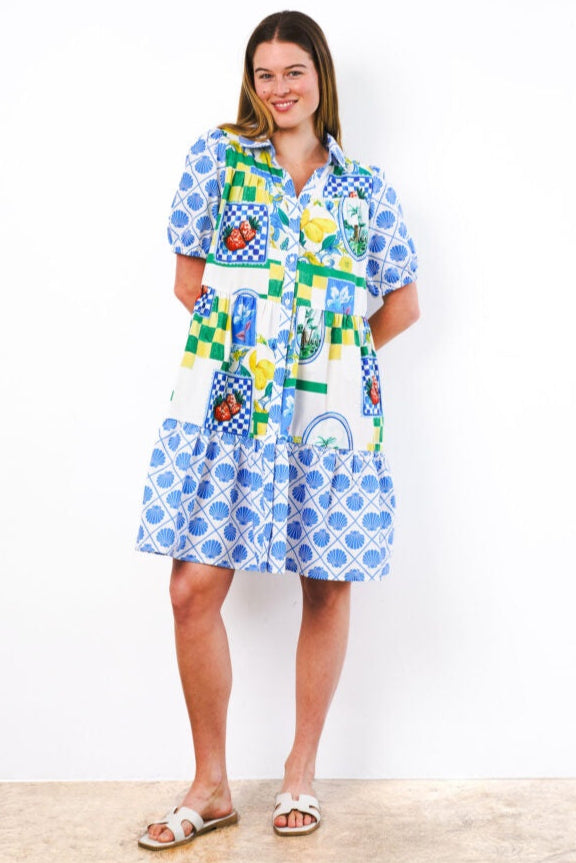 Woman wearing a colorful dress with a pattern on a white background