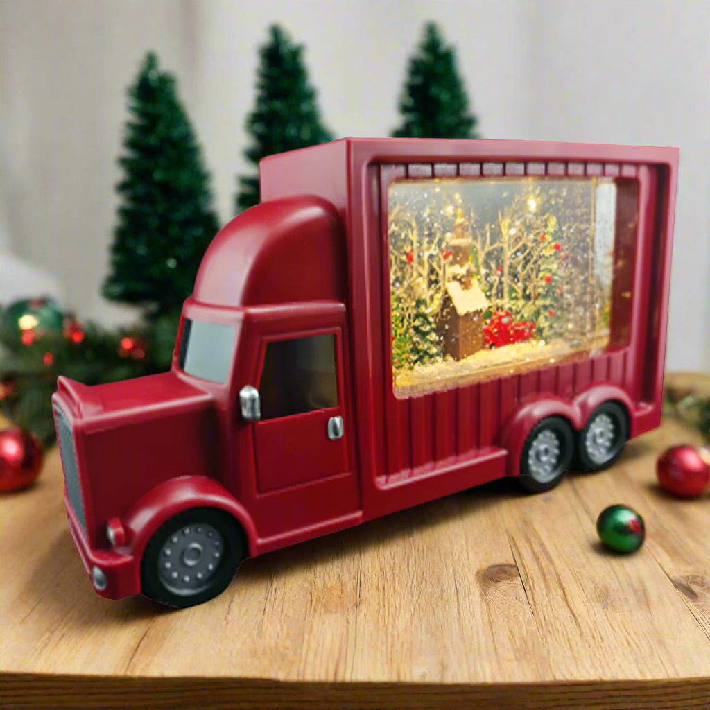 Red truck-shaped decorative item with a lit-up interior on a white background