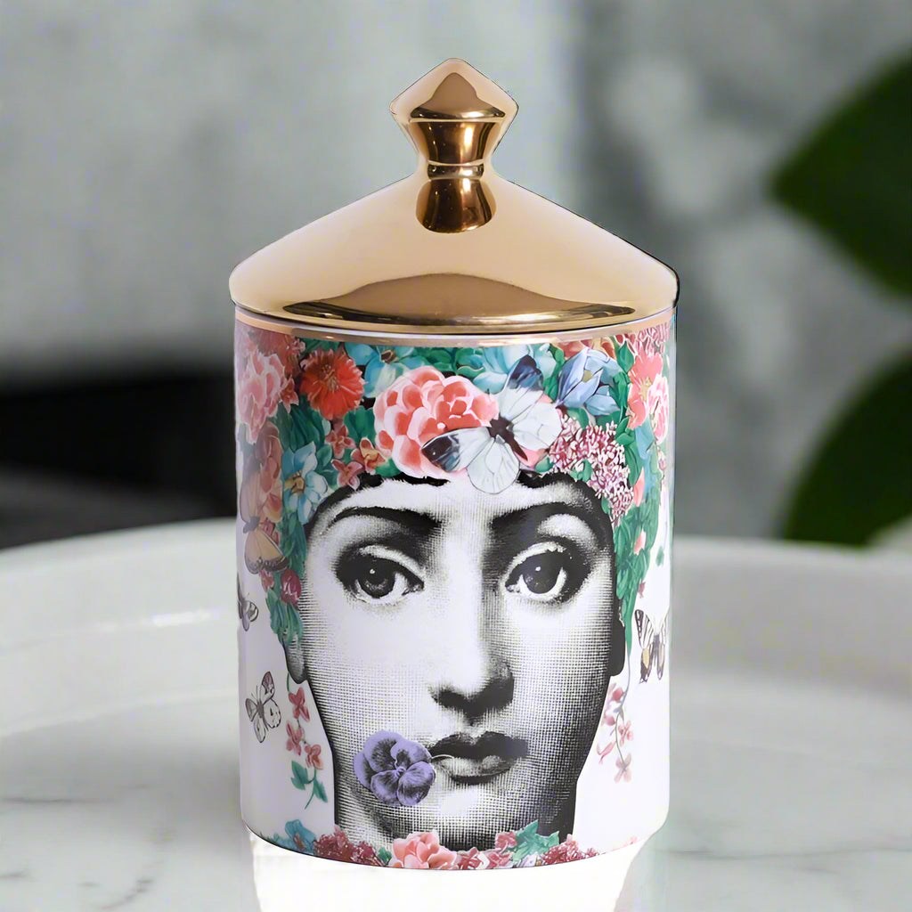 Decorative jar with floral design and gold lid on a white background