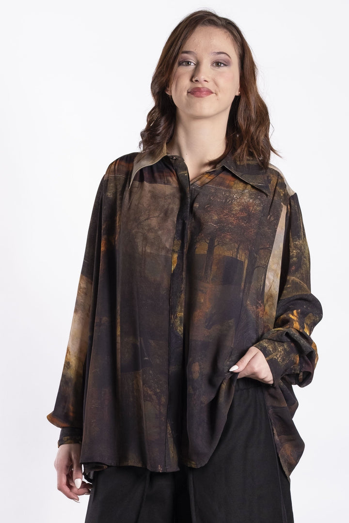 Woman wearing a patterned Deeanne Hobbs shirt and black pants on a white background