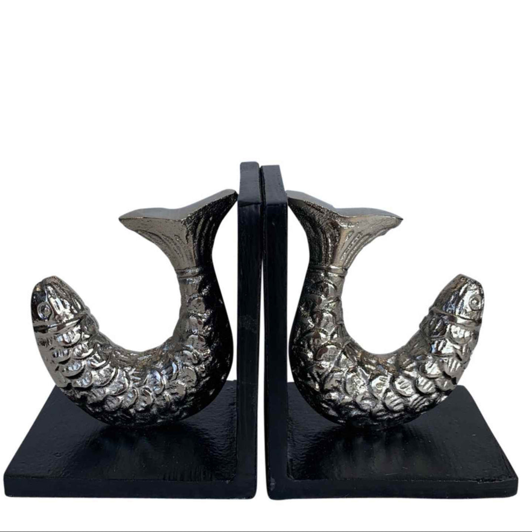 Pair of decorative bookends with fish design on a white background