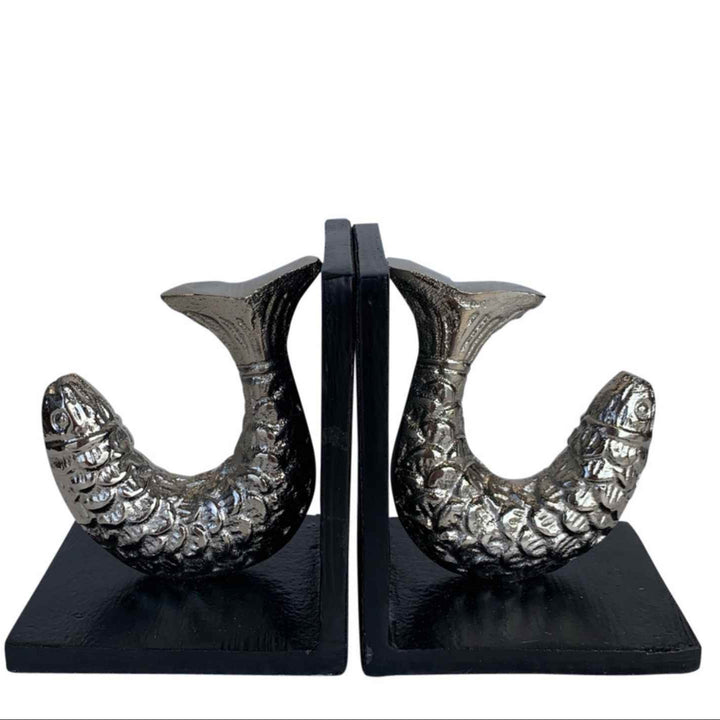 Pair of decorative bookends with fish design on a white background