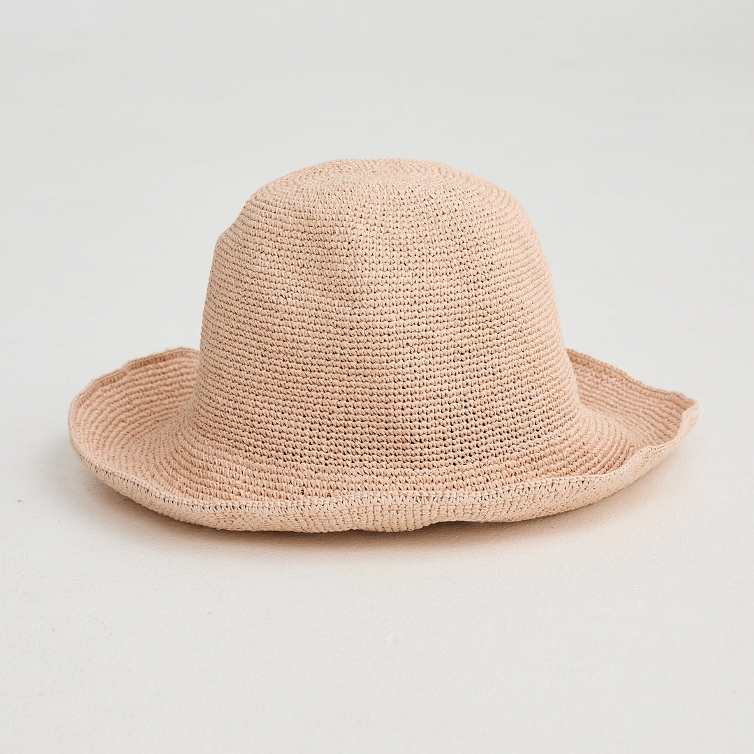 Beige straw hat on a light gray background
