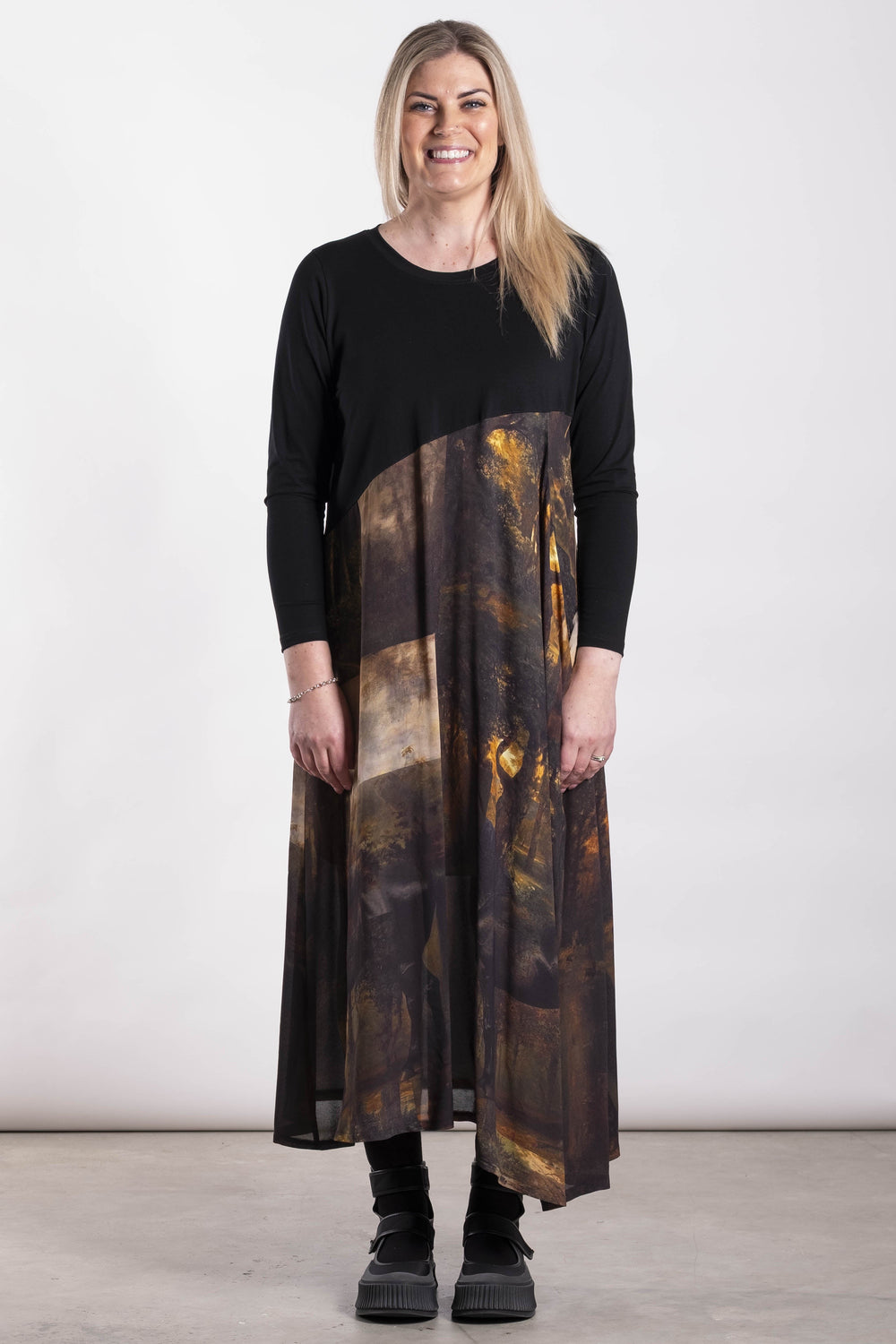 Woman wearing a black and patterned Deeanne Hobbs Observe Dress on a white background