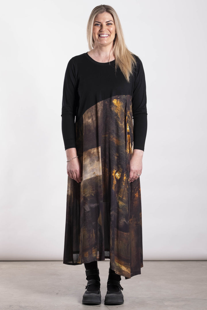 Woman wearing a black and patterned Deeanne Hobbs Observe Dress on a white background