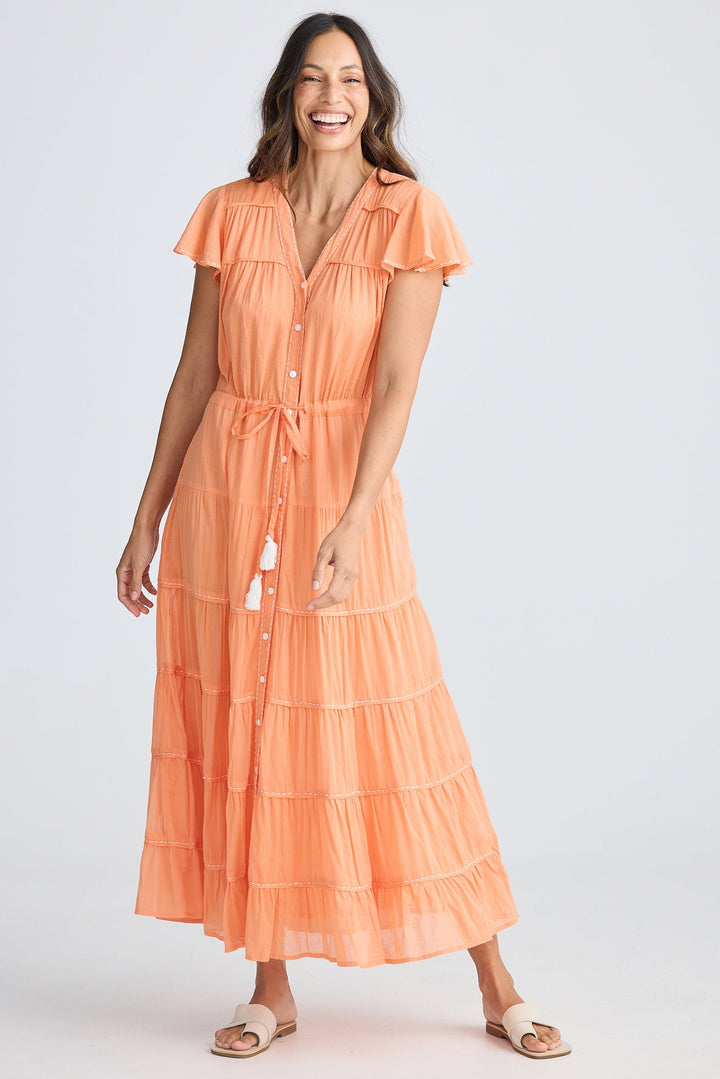 Woman wearing an orange dress on a white background