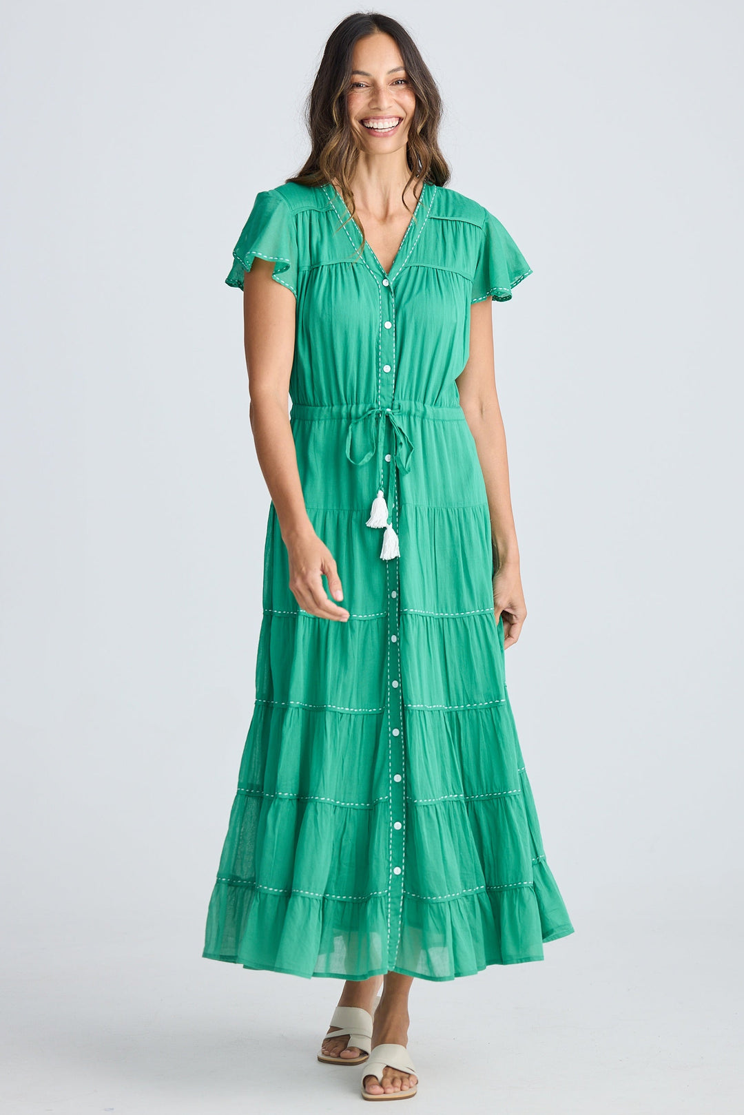 Woman wearing a green dress on a white background