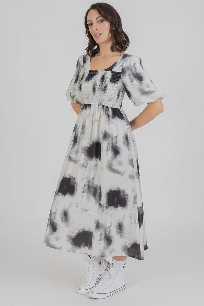 Woman wearing a tie-dye federation dress with a plain background