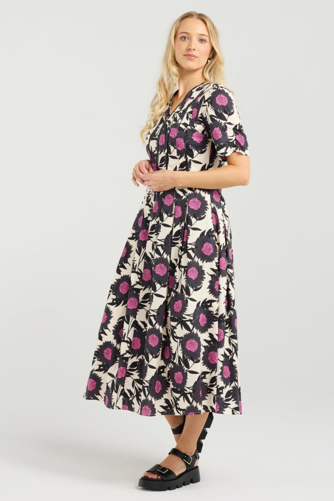 Woman wearing a floral dress on a white background