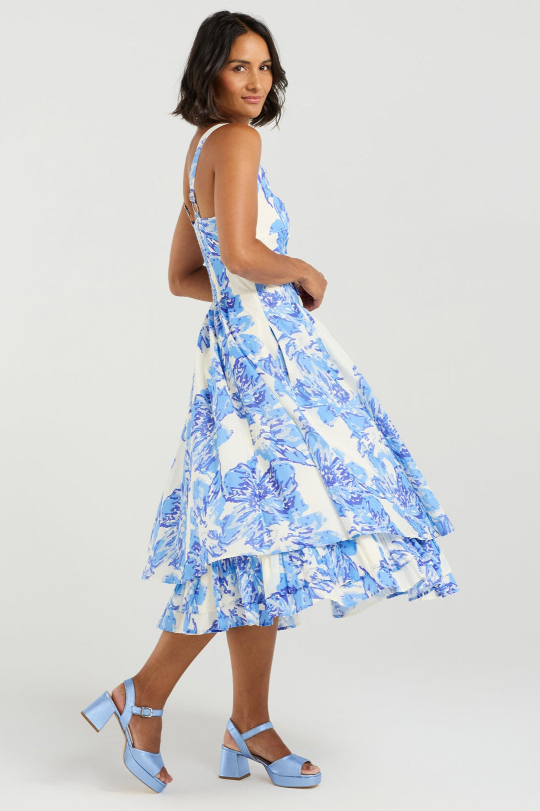 Woman wearing a blue floral dress on a white background