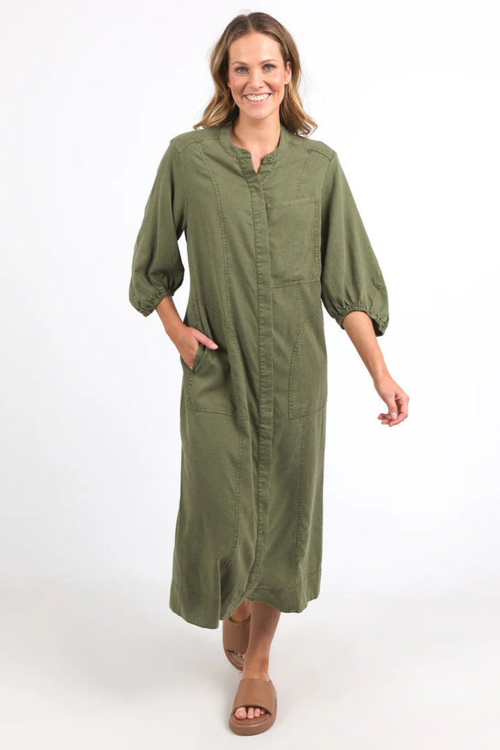 Woman wearing a green dress on a white background