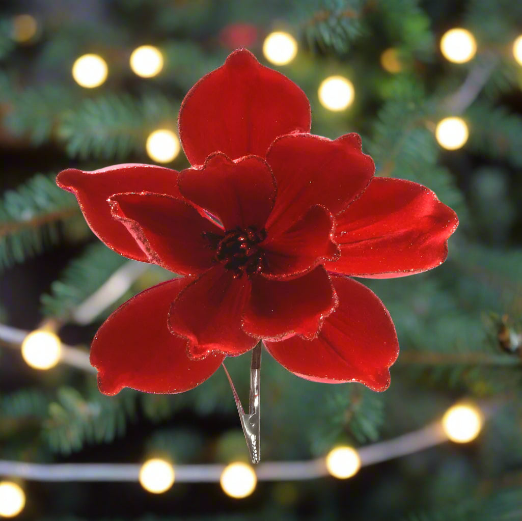Red flower-shaped hair clip on a white background