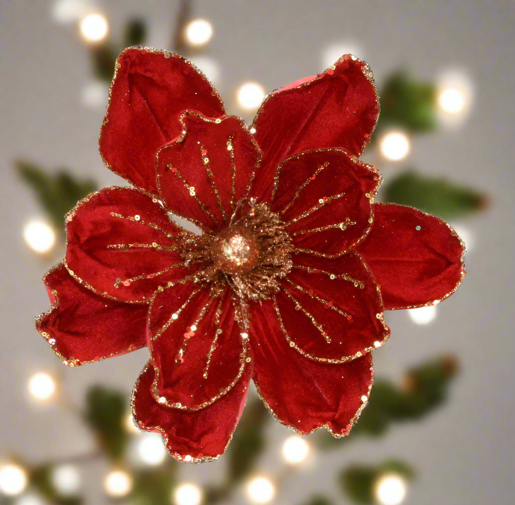 Decorative red flower with gold accents on a white background