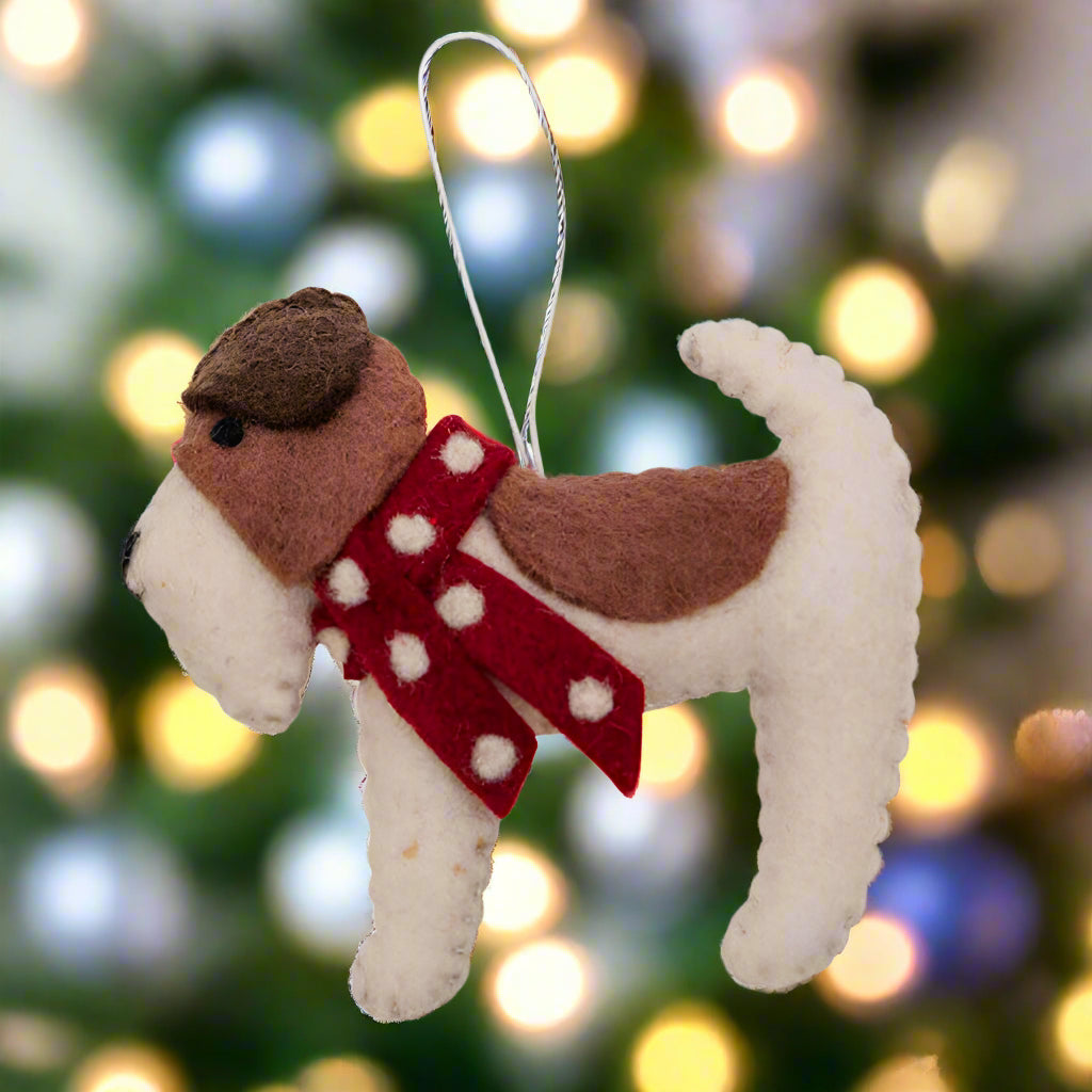 Dog-shaped ornament with a red scarf on a white background