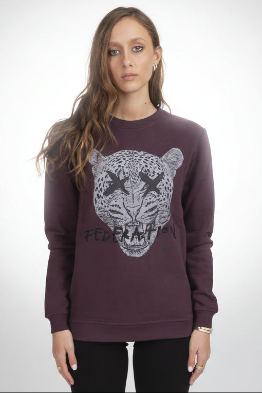 Woman wearing a maroon sweatshirt with a tiger graphic and 'Federika' text on a white background