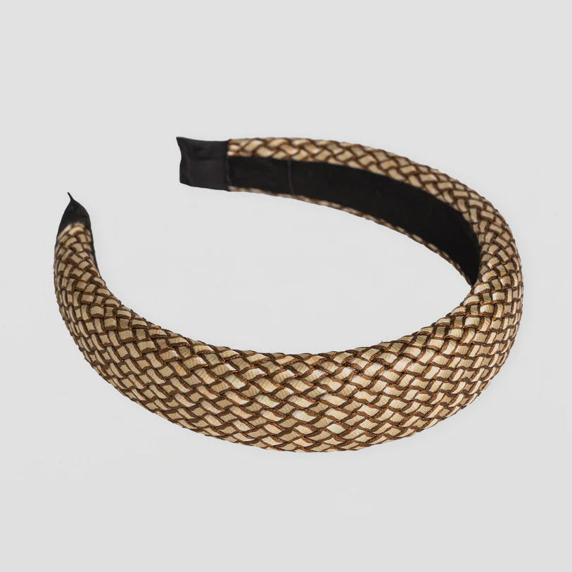 Woven headband with black center on a light gray background