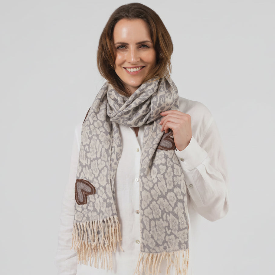 Woman wearing a patterned scarf against a white background