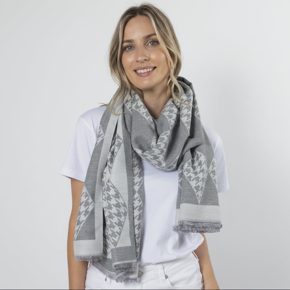 Woman wearing a gray patterned scarf on a white background