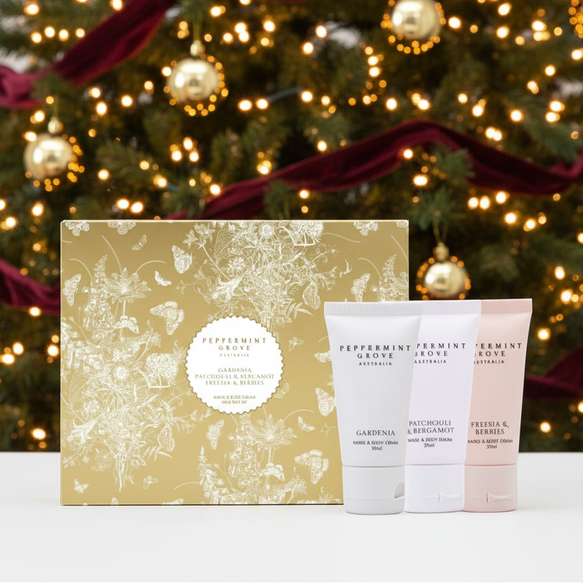 Peppermint Grove Gardening hand and body care set featuring a gold floral gift box and three squeeze tubes of hand and body cream and wash in white and pale pink.