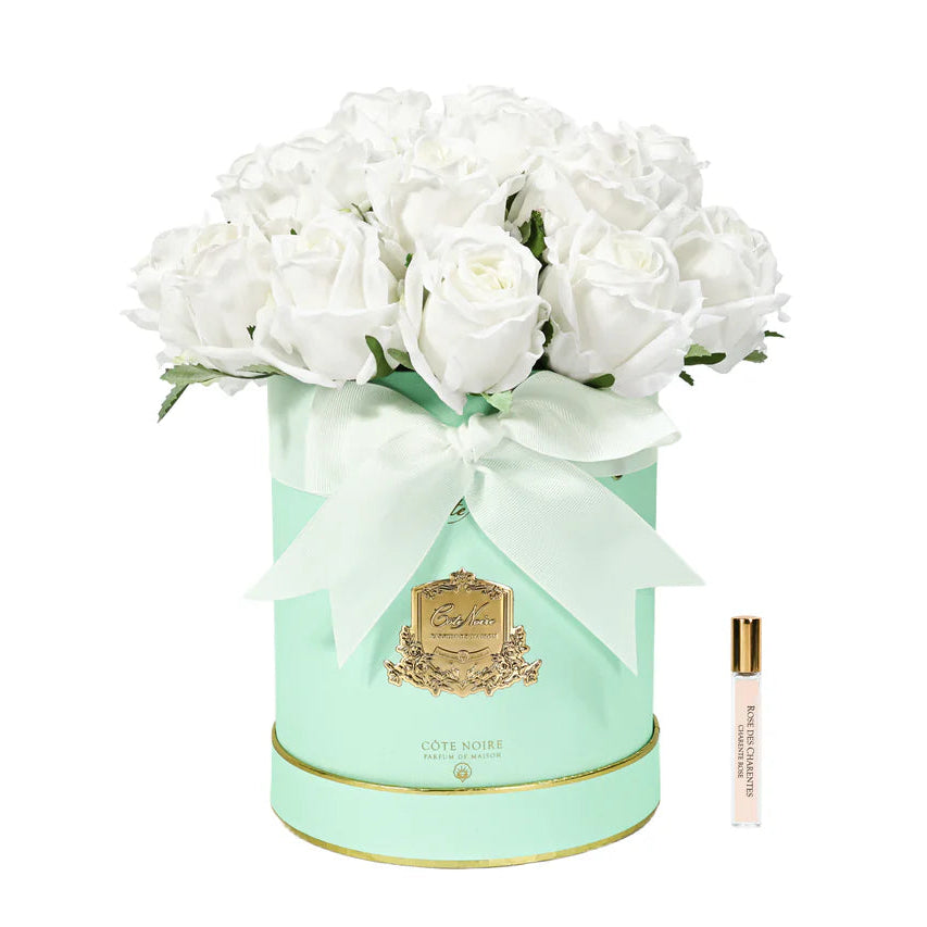 White flowers in a decorative green box with a gold emblem on a white background