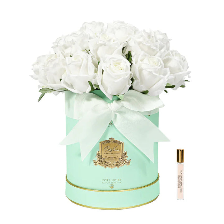 White flowers in a decorative green box with a gold emblem on a white background