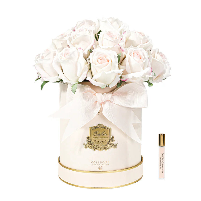 White flowers in a decorative box with a perfume bottle on a white background
