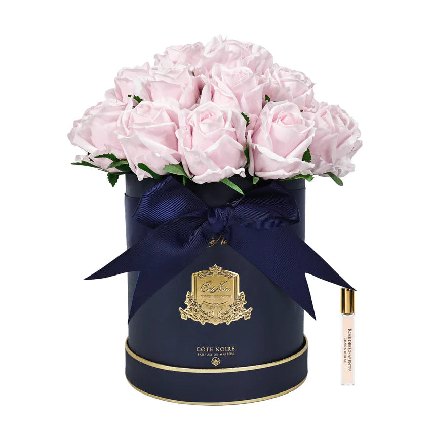 Navy blue round box with pink roses and a navy ribbon on a white background