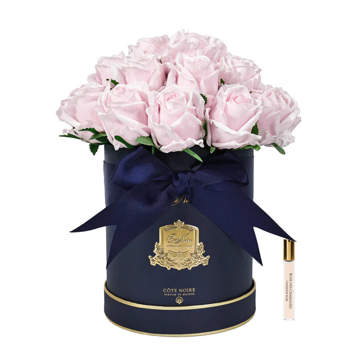 Navy blue round box with pink roses and a navy ribbon on a white background