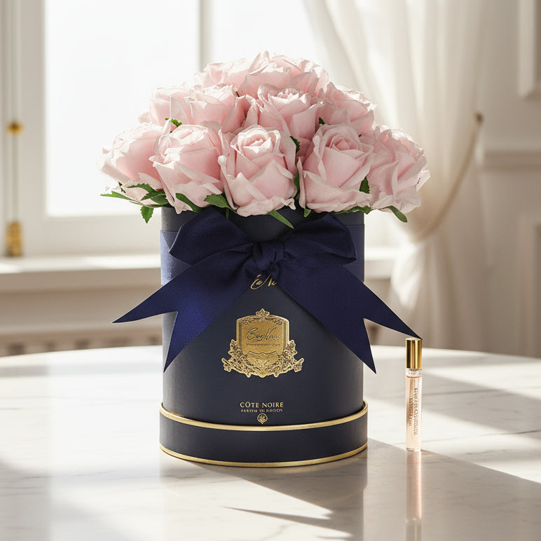Navy blue box with pink cote noire flower bouquet and a visible brand logo.