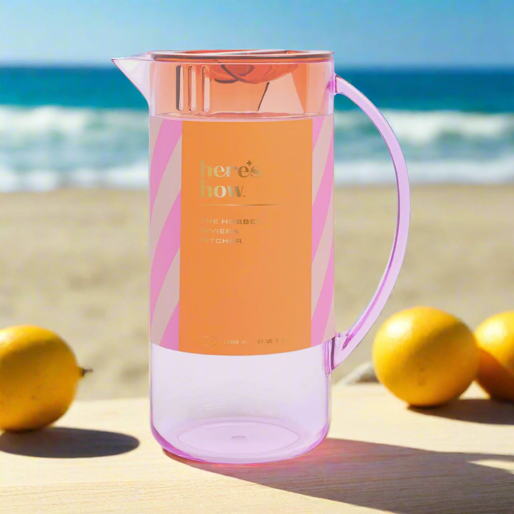 Pink and orange pitcher with 'here's how' text on a light gray background