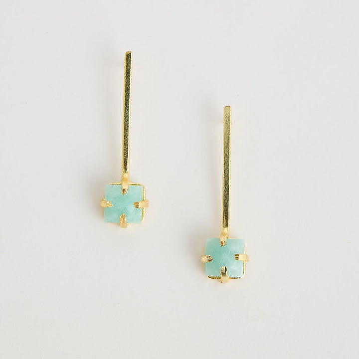 Pair of turquoise earrings on a light gray background