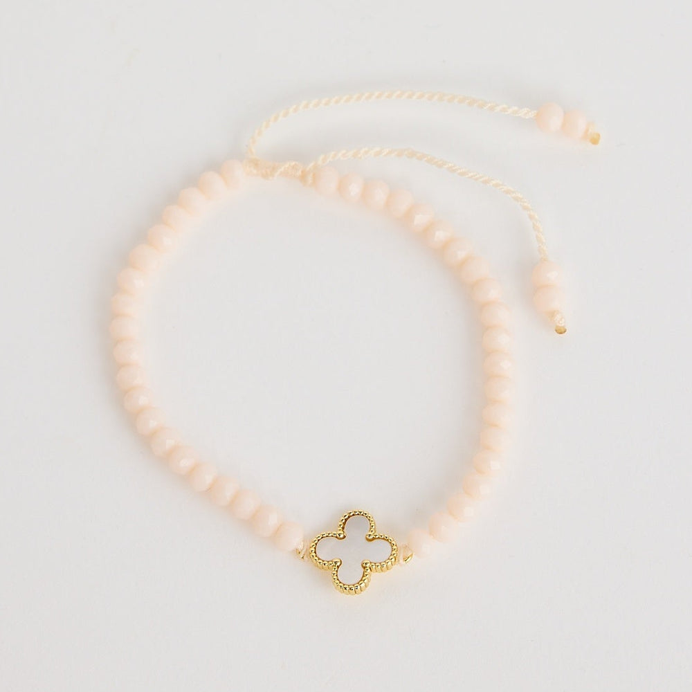 Gold necklace with a butterfly pendant on a light gray background