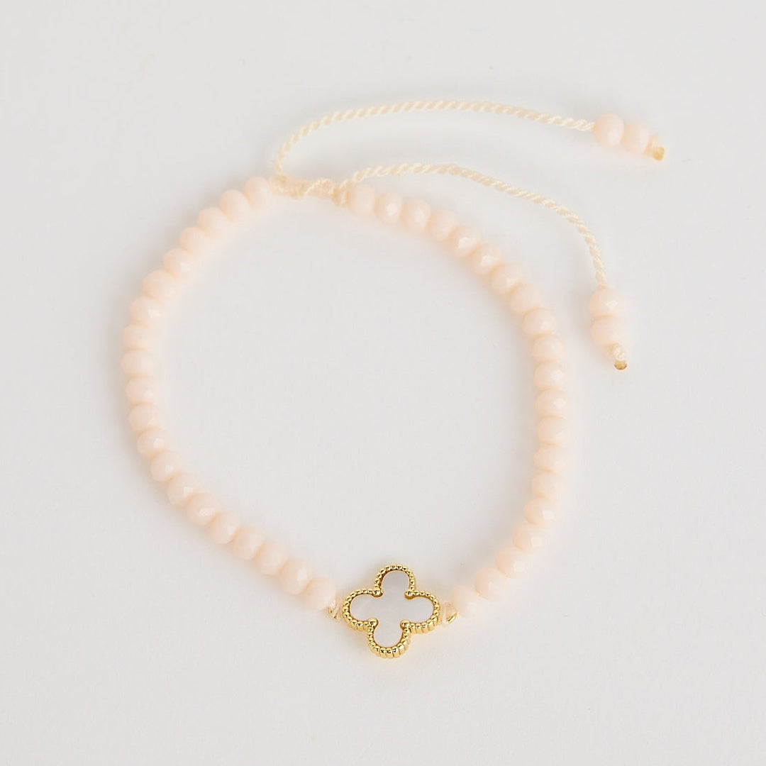 Gold necklace with a butterfly pendant on a light gray background