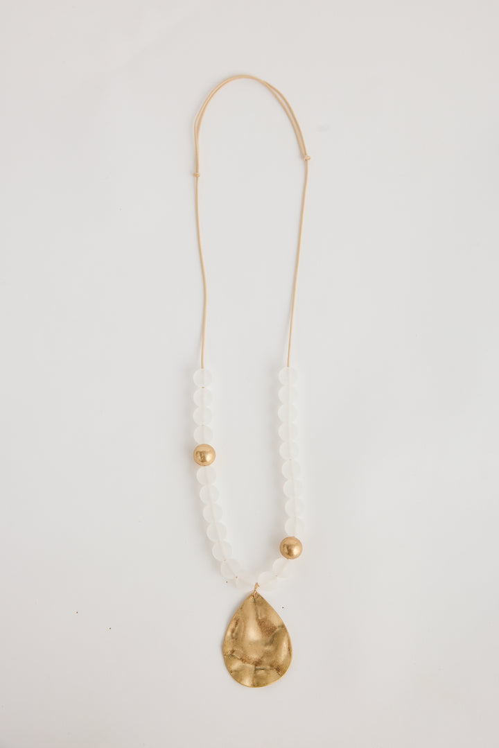 Necklace with a gold teardrop pendant on a white background