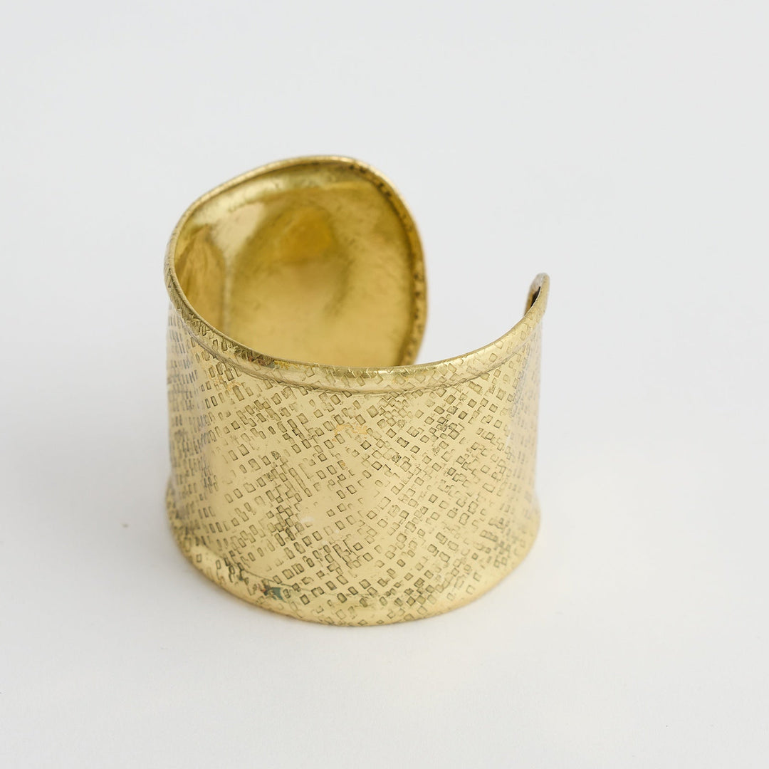 Gold textured ring on a white background