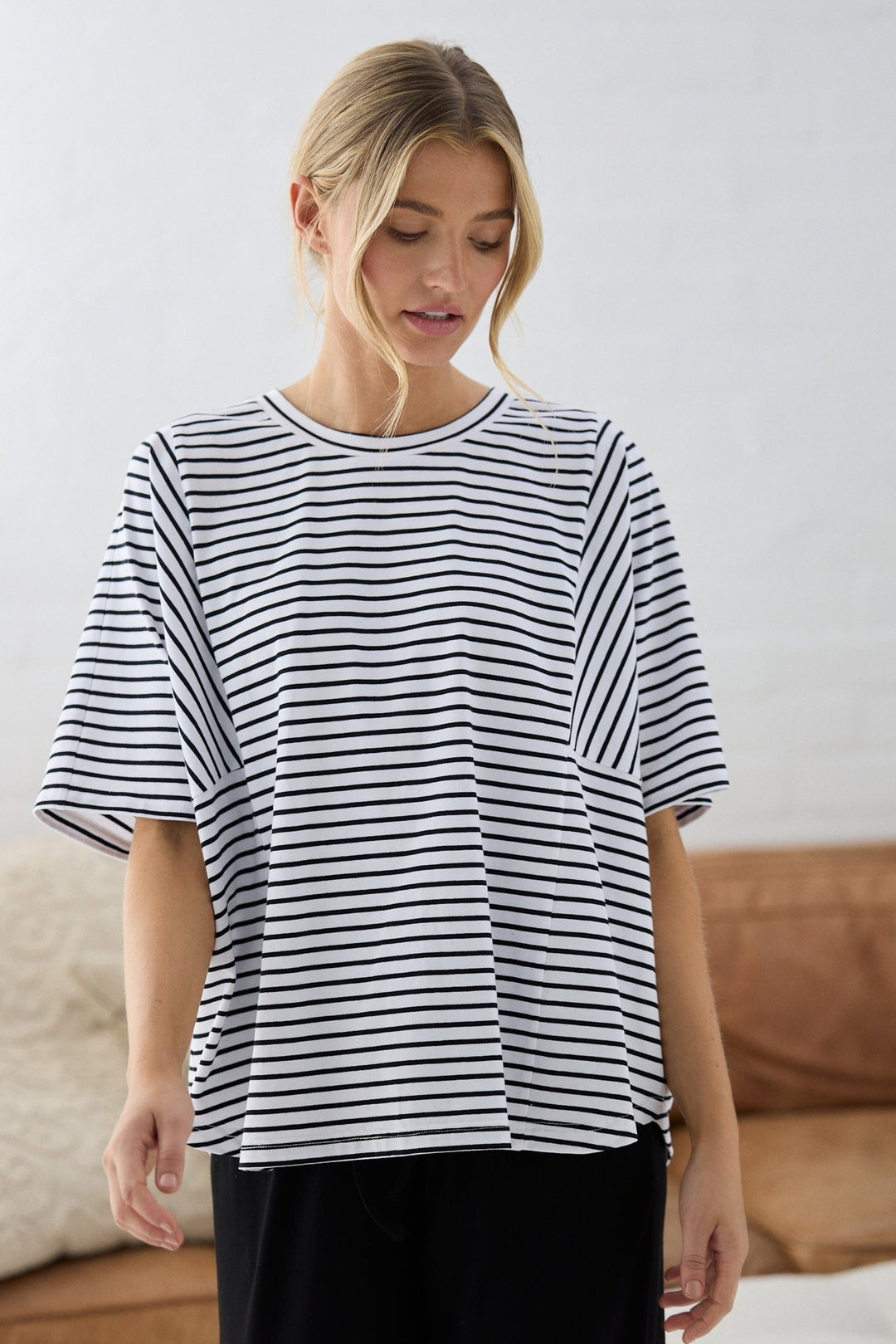 Woman wearing a black and white striped shirt in a casual setting