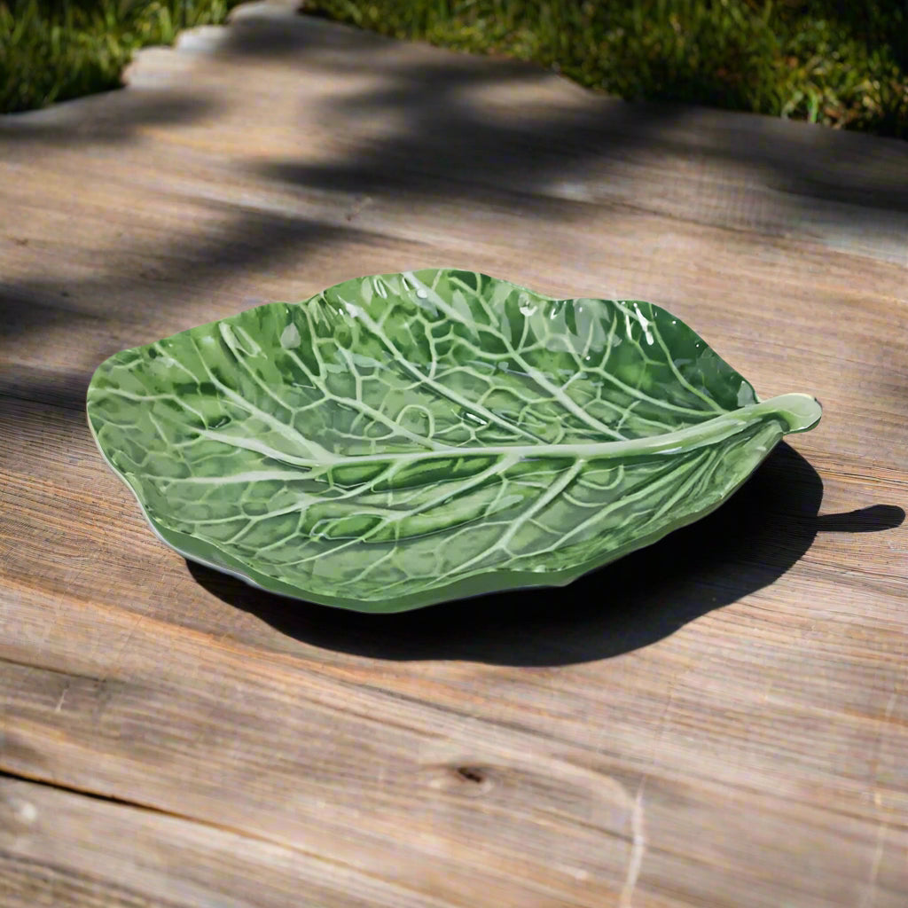 Green leaf-shaped dish on a white background