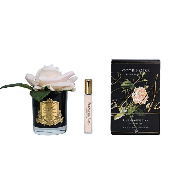 Cote Noire perfume bottle and packaging with a rose on a white background