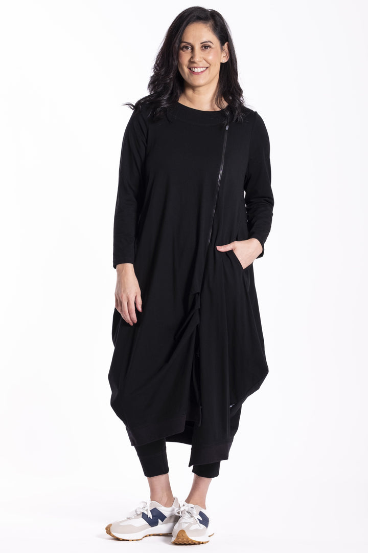 Woman wearing a black Jellicoe Urban Fold dress with a white background